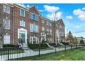 Attractive townhome exteriors with brick facade, complemented by well-maintained lawns and sidewalks at 8613 N Meridian St, Indianapolis, IN 46260
