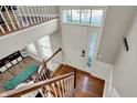 Bright foyer with wood floors, featuring a staircase, large window and front door at 8613 N Meridian St, Indianapolis, IN 46260
