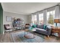 Bright living room featuring a large window, plush gray couch, and stylish decor at 8623 Appleby Ln, Indianapolis, IN 46256
