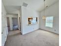 Open dining area featuring neutral carpet, a hanging light fixture and open to the kitchen at 934 Sorrell Ct, Lebanon, IN 46052