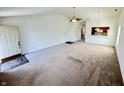 Spacious living room with neutral carpet, ceiling fan and an open view to the front door at 934 Sorrell Ct, Lebanon, IN 46052