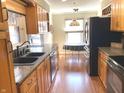 Traditional kitchen with stainless steel appliances, wood cabinets, and a breakfast nook area at 1054 Carters Grove, Indianapolis, IN 46260