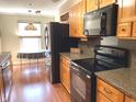 Charming kitchen with wood cabinets, granite countertops, and breakfast nook with lots of light at 1054 Carters Grove, Indianapolis, IN 46260