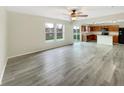 Open-concept living area with wood-look flooring, natural light, and seamless flow to the kitchen at 10719 Crackling Dr, Indianapolis, IN 46259