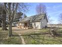 Expansive backyard view featuring a cozy covered porch and mature trees at 11686 S 825 W, Edinburgh, IN 46124