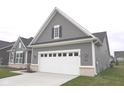 Attached, two-car garage with white door and gray exterior, adjacent to the main house at 1274 Clairet, Westfield, IN 46074