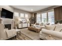 Comfortable living room with fireplace, plantation shutters and neutral decor at 12889 Copper Run Blvd, Carmel, IN 46074