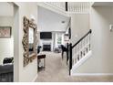 Inviting entryway with a view of the living room and staircase, showcasing an open and airy layout at 14534 Baldwin Ln, Carmel, IN 46032