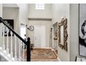 Bright and open entryway featuring hardwood floors, a decorative rug, and high ceilings, creating a welcoming ambiance at 14534 Baldwin Ln, Carmel, IN 46032