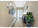 A bright hallway with wood floors, neutral paint, and decor at 1684 Beach St, Greenwood, IN 46143