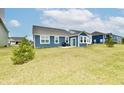 Spacious backyard with blue vinyl siding home and patio area for outdoor enjoyment at 1803 Jackson St, Fortville, IN 46040