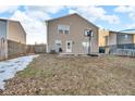 Spacious backyard featuring a patio area, a basketball hoop, and a well-maintained lawn at 1847 Dutch Elm Dr, Indianapolis, IN 46231