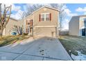 Charming two-story home featuring red shutters, a two-car garage, and a well-maintained front yard at 1847 Dutch Elm Dr, Indianapolis, IN 46231