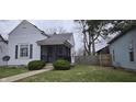 Charming home featuring a quaint screened-in front porch and tidy landscaping at 2028 George St, Anderson, IN 46016
