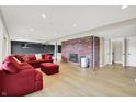 Spacious finished basement with wood flooring, a brick fireplace, and a comfortable seating area at 22 Point Ln, Arcadia, IN 46030