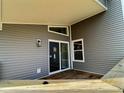 Close-up view of backyard deck with gray siding and sliding door entrance at 2620 E 56Th St, Indianapolis, IN 46220