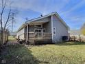 Back of the house with a spacious wooden deck and gray siding at 2620 E 56Th St, Indianapolis, IN 46220