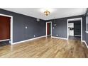 Spacious living room with wood floors, black walls, and elegant lighting at 2702 N Talbott St, Indianapolis, IN 46205