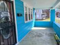 Covered porch area featuring light blue siding and ample space, perfect for relaxing outdoors at 3035 Graceland Ave, Indianapolis, IN 46208