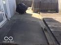 Patio area with concrete pad and wooden deck at 3036 Chase St, Indianapolis, IN 46217