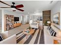 Bright and airy living room featuring hardwood accents, modern furniture, and a large window view at 3313 Capsella Ln, Indianapolis, IN 46203