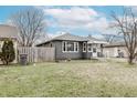 Well-maintained single-story home featuring a classic design and a spacious front yard at 4910 East 21St St, Indianapolis, IN 46218