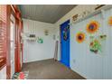 Inviting entryway featuring a vibrant blue door, carpet floor, and charming decorations at 502 E Washington St, Summitville, IN 46070