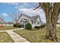 Charming single-story home with gray siding, manicured landscaping, and a welcoming front entrance at 502 E Washington St, Summitville, IN 46070