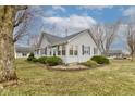 Charming single-story home with gray siding, manicured landscaping, and a welcoming front entrance at 502 E Washington St, Summitville, IN 46070