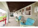 Relaxing covered front porch featuring comfortable chairs and a tranquil setting, perfect for enjoying outdoor living at 518 N Emerson Ave, Indianapolis, IN 46219