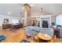 Spacious living area with hardwood floors, and a unique brick column offering a blend of comfort and architectural detail at 518 N Emerson Ave, Indianapolis, IN 46219