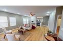 Spacious living room with hardwood floors, modern furniture, fireplace, and large windows overlooking backyard at 5180 Dunewood Way # 57, Avon, IN 46123