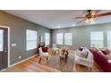 Bright living room featuring hardwood floors, neutral walls, large windows, and stylish furniture at 5180 Dunewood Way # 57, Avon, IN 46123