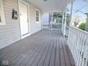 Inviting porch with classic white railings, a wood floor, and a glimpse of the outdoors at 55 S 4Th Ave, Beech Grove, IN 46107