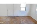 Bright room ready for your personal touch, featuring a door and windows at 55 S 4Th Ave, Beech Grove, IN 46107