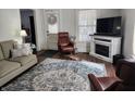 Comfortable living room with a fireplace, recliner chair, sofa, and a decorative rug at 611 W South St, Shelbyville, IN 46176