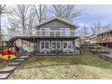 Charming home features a large deck with lake views, with stairs to access the yard at 6290 Grouse Dr, Nineveh, IN 46164