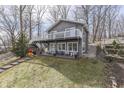 Charming home features a large deck with lake views, with stairs to access the yard at 6290 Grouse Dr, Nineveh, IN 46164