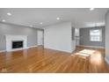 Bright living room with hardwood floors, fireplace, and fresh paint at 6407 Brokenhurst Rd, Indianapolis, IN 46220