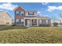 Charming two-story brick home with a covered front porch and well-maintained lawn at 7185 Laredo Dr, McCordsville, IN 46055