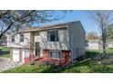Side view of a two-story home with a brick foundation, and a fenced yard at 7733 Opelika Ct, Indianapolis, IN 46217