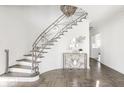 Elegant foyer featuring a curved staircase with decorative iron railings and herringbone wood floors at 8020 N Meridian N St, Indianapolis, IN 46260