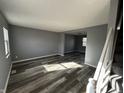 Bright living room with gray walls and modern wood-look floors, perfect for relaxing or entertaining guests at 8054 Harvest Ln, Indianapolis, IN 46256