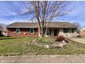 Charming single story house with brick and vinyl siding and flower bed at 810 Fabyan Rd, Indianapolis, IN 46217