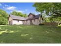 A large front lawn highlights this home's exterior with mature trees and plenty of curb appeal at 859 E Bunkerhill Rd, Mooresville, IN 46158
