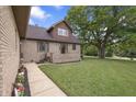 A walkway leads to this home's front door with a well-maintained lawn and mature trees at 859 E Bunkerhill Rd, Mooresville, IN 46158