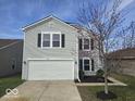 Attractive two-story home with gray siding, white garage door, and manicured landscaping at 10915 Mansfield Way, Ingalls, IN 46048