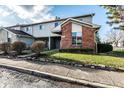 Charming two-story townhouse with brick accents and manicured landscaping at 11931 E Welland St, Indianapolis, IN 46229