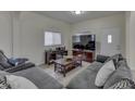 Comfortable living room with a large grey sectional sofa, wood coffee table, and modern entertainment center at 1231 S Pershing Ave, Indianapolis, IN 46221