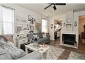 Cozy living room with fireplace and view into the kitchen area at 15524 Dusty Trl, Noblesville, IN 46060